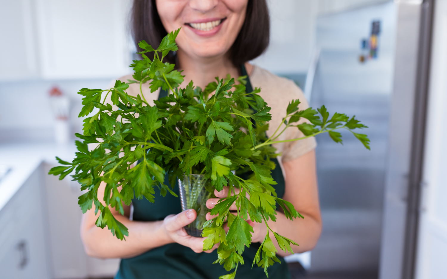 Woman smilling holding parsley in hands, ideas touse your greens bfore they wilt, Health and Yum food blog